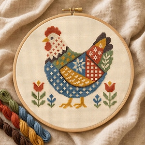 May include: A circular wooden embroidery hoop containing a cross-stitch pattern of a chicken with a patchwork-style body in blue, red, yellow, and green. The chicken is flanked by small red and blue flowers on a cream-colored fabric background.