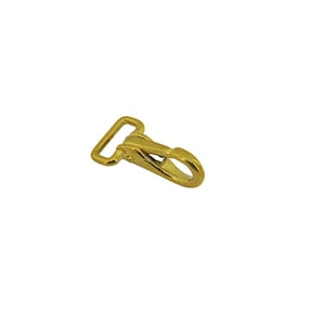 May include: A gold-colored metal swivel lobster clasp featuring a rectangular loop at one end and a spring-loaded gate mechanism. The hardware has a smooth, reflective finish and is designed for attaching straps or accessories to various items.