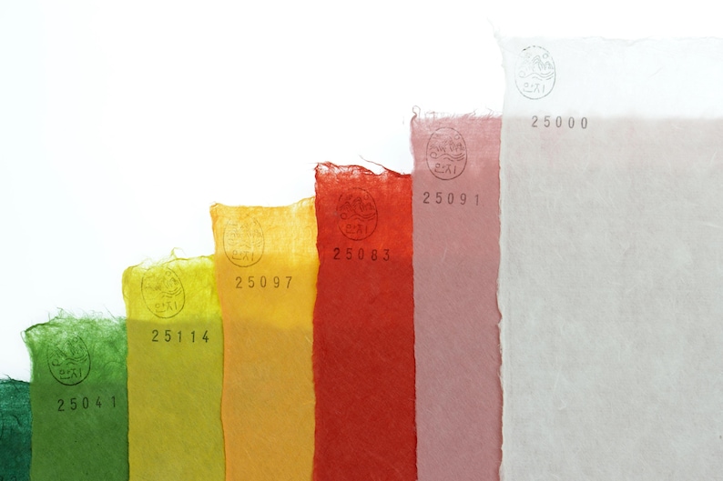 May include: A set of rectangular sheets of textured paper arranged in a stepped pattern, featuring colors of dark green, light green, yellow, orange, red, pink, and white. Each sheet displays a circular stamp and a unique five-digit number.