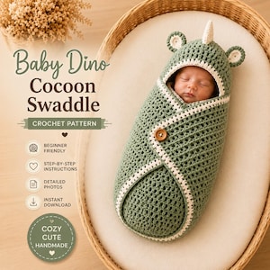 May include: A sage green crochet baby cocoon swaddle featuring a hood with small ears and a central horn. The swaddle has a white trim, a single wooden button closure, and text reading Baby Dino Cocoon Swaddle Crochet Pattern with icons.