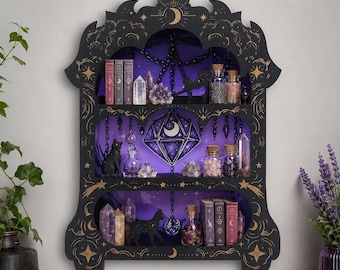 May include: A black wall-mounted shelf with three tiers, featuring gold celestial engravings of moons and stars. The shelf displays various crystals, small glass bottles, books, and black cat figurines against a purple backdrop with a central diamond.