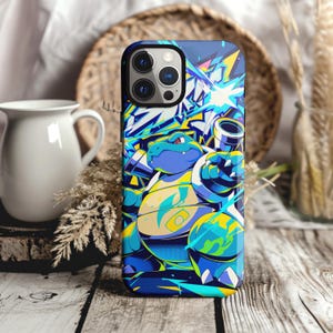 May include: A smartphone case featuring a vibrant, multi-colored graphic illustration of a blue, turtle-like creature with cannons on its back. The design incorporates sharp, angular lines and bright yellow, light blue, and dark blue color accents.