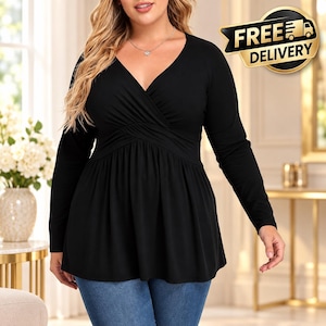 May include: A black long-sleeve top featuring a V-neckline with a wrap-style bodice and a gathered waistline that flares into a peplum hem. The garment is paired with blue denim jeans and includes a silver necklace with a small pendant.