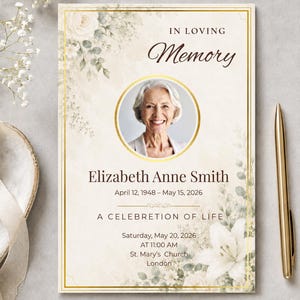 May include: A rectangular funeral program card featuring a gold border, white floral illustrations, and a circular photo of a smiling person. The text reads: IN LOVING Memory, Elizabeth Anne Smith, April 12, 1948 – May 15, 2026, A CELEBRETION OF LIFE, Saturday, May 20, 2026, AT 11:00 AM, St. Mary’s Church, London.