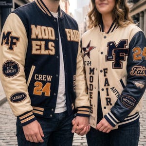 May include: Two varsity jackets featuring navy blue and cream colour blocking with embroidered patches and lettering. The left jacket displays "MODELS", "CREW 24", and "S.J. CLUB". The right jacket features "MF", "24", and "FAIR" text with star accents.