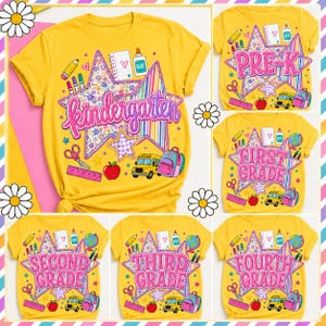 May include: A bright yellow t-shirt featuring a large star graphic with school supplies including a pencil, glue, scissors, a ruler, a school bus, and a backpack. The text reads Kindergarten, Pre-K, First Grade, Second Grade, Third Grade, or Fourth Grade.