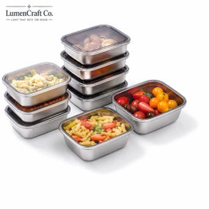 May include: A set of rectangular stainless steel food storage containers with clear lids. Some containers are stacked, while others are filled with pasta, cherry tomatoes, and various food items. The LumenCraft Co. logo is visible at the top.