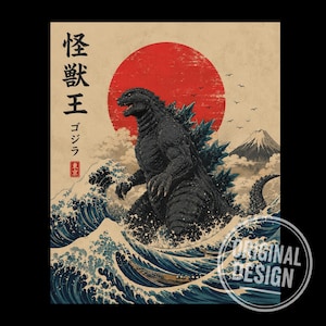 May include: A graphic print featuring a dark, textured Godzilla standing amidst stylised blue ocean waves. A large red sun sits in the background behind a mountain peak. Japanese characters are printed vertically on the left side of the artwork.