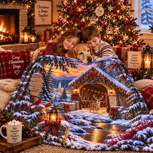 May include: A soft throw blanket featuring a winter landscape with a snow-covered wooden bridge, a deer, and a sign that reads Good Leads Home. The scene includes pine trees, a church, and lanterns. A white mug with Hot Chocolate and Christmas Magic text.