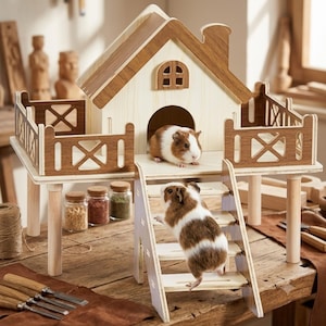 May include: A two-story wooden house structure for small animals featuring a light-colored main cabin with a dark wood roof and trim, a fenced balcony, and a set of stairs leading up to the entrance, occupied by two brown and white guinea pigs.