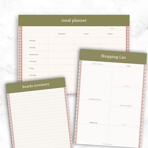 May include: Three paper planning sheets with olive green headers and scalloped pink edges. The sheets are labeled meal planner, shopping list, and snacks inventory. The meal planner has columns for breakfast, lunch, and dinner. The shopping list has sections for produce, fruits, bakery, chilled, frozen, house supplies, and wellbeing. The snacks inventory is a lined page.