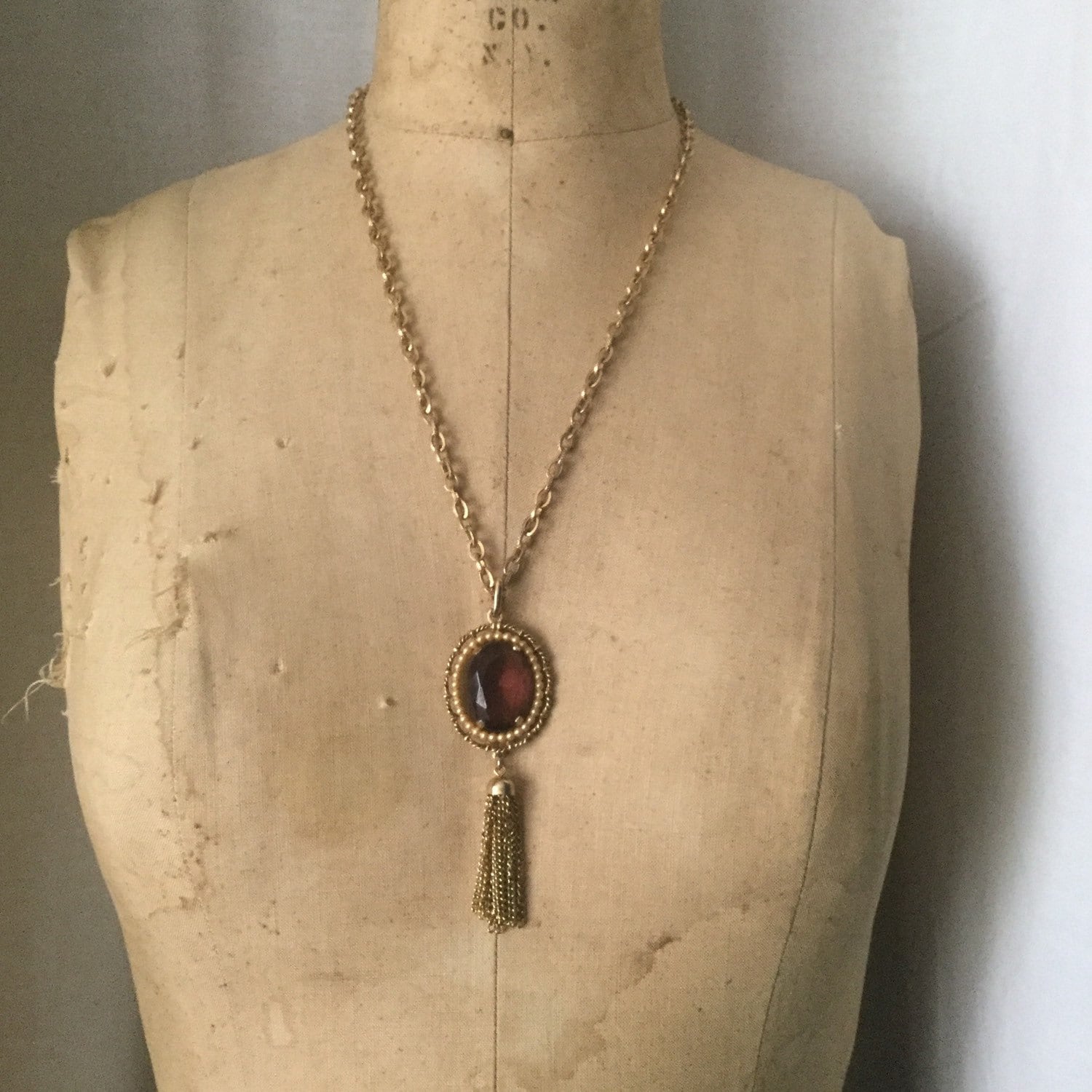 Vintage Avon gold with amethyst glass pendant and tassel necklace.