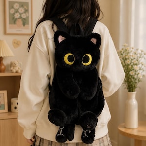 May include: A plush black cat backpack featuring large yellow embroidered eyes, pointed ears with pink inner details, and dangling paws at the bottom. The backpack has black shoulder straps and a soft, fuzzy texture, designed to resemble a cat.