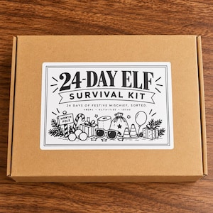 May include: A rectangular brown cardboard box featuring a white rectangular label with black text and illustrations. The label reads 24-DAY ELF SURVIVAL KIT 24 DAYS OF FESTIVE MISCHIEF, SORTED. PROPS ACTIVITIES IDEAS with drawings of gifts, sunglasses, and a North Pole sign.