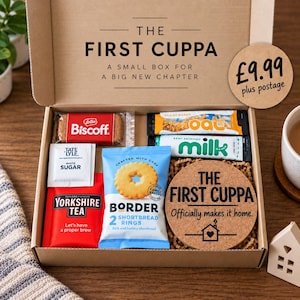 May include: A cardboard gift box labelled The First Cuppa containing a Biscoff biscuit, a Tate and Lyle white sugar packet, a Yorkshire Tea bag, an oat bar, a milk stick, a pack of Border shortbread rings, and a round cork coaster with text.