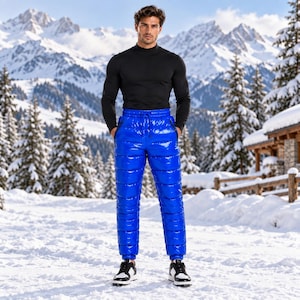 May include: A black long-sleeve mock neck shirt paired with bright blue, high-gloss, quilted puffer pants featuring an elastic drawstring waistband, side zipper pockets, and cuffed ankles, worn with black and white athletic sneakers.