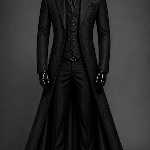 May include: A black three-piece suit featuring a long, knee-length coat with a subtle tonal damask pattern, a matching button-up vest, a black dress shirt, a dark necktie, and tailored trousers, all displayed on a mannequin with black shoes.