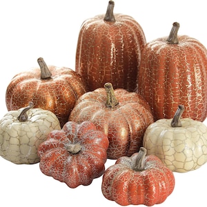 May include: A collection of eight decorative pumpkins in varying sizes, featuring a crackled finish in shades of burnt orange, copper, and cream. Each pumpkin is topped with a brown stem and displays a distinct webbed texture across its surface.