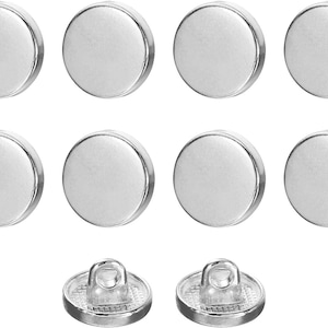 May include: A set of ten circular silver-toned buttons arranged in three rows. Eight buttons are shown from the top, displaying a smooth, reflective, metallic surface. Two buttons are positioned at the bottom, showing the back with a loop shank.