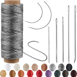 May include: A spool of grey waxed thread with a loose end, two curved sewing needles, and four straight needles. Below the spool are eighteen small, circular samples of thread in various colors including white, tan, red, and black.