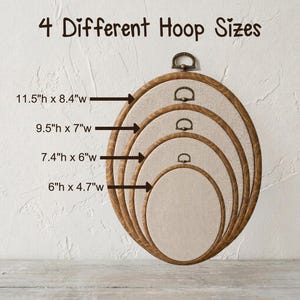 May include: Four oval embroidery hoops with wood-grain frames and beige fabric centers, nested together. Text reads 4 Different Hoop Sizes with dimensions: 11.5"h x 8.4"w, 9.5"h x 7"w, 7.4"h x 6"w, and 6"h x 4.7"w, each with a metal hanging loop.