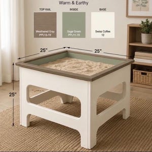 May include: A square sand table with a white base, sage green interior, and a weathered gray top rail. The table measures 25 inches in width, depth, and height. Color swatches labeled Warm & Earthy show the paint colors used for the structure.