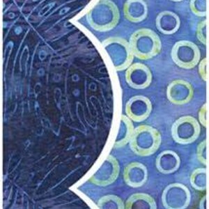 May include: A blue and white fabric with a scalloped edge. One side features a pattern of blue and white circles, while the other side has a more intricate design of blue and white leaves.