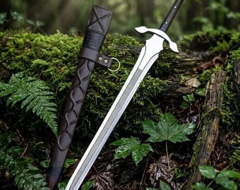 May include: A silver-toned metal sword with a black handle and a crossguard, accompanied by a dark brown leather scabbard featuring a decorative embossed pattern, a strap, and a brass-coloured metal ring attachment for secure carrying.
