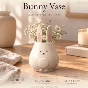 May include: A ceramic bunny vase slab pottery template featuring the text Bunny Vase Slab Pottery Template. The vase is cream-colored with speckled details, pink-accented ears, and a simple face. It measures 16.5 cm tall and 10.8 cm wide.