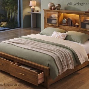 May include: A wooden bed frame with a headboard featuring integrated storage cabinets, glass doors, and internal lighting. The base includes two pull-out storage drawers. The bed is dressed with a sage green duvet, a cream throw, and pillows.