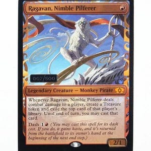 May include: A Magic: The Gathering trading card titled Ragavan, Nimble Pilferer, featuring a white monkey pirate illustration, a red mana symbol, and text detailing the legendary creature's abilities, with a 007/500 serial number stamp.