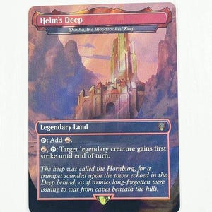 May include: A rectangular trading card titled Helm's Deep, Shinka, the Bloodsoaked Keep. The artwork depicts a tall stone fortress nestled between rocky mountains under a sunset sky. The card text includes game rules and flavor text in white.