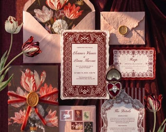 May include: A wedding stationery set featuring a main invitation with a dark red lace border, a matching RSVP card, a details card, and envelopes. One envelope has a floral interior, another a gold wax seal, and a third has vintage postage stamps.