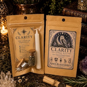 May include: Two tan paper pouches containing a Clarity spell kit by Rowan Blackthorn's Apothecary. The kits include a white candle, a small glass jar with herbs, a metal star charm, and a scroll. The labels feature an owl, moon, and text.