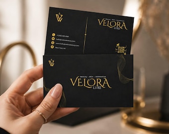May include: Two rectangular black business cards featuring gold text and graphics. The cards display the logo and text VELORA LUXE, Beauty Skin Aesthetics, contact information, a QR code, and a stylized gold line design on a matte black background.