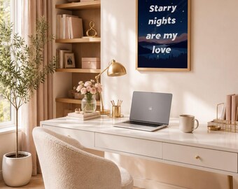 May include: A framed wall art print featuring a dark blue night sky over a landscape with mountains and water, displaying the white text "Starry nights are my love" in a bold, sans-serif font, hanging on a light-colored wall above a desk.