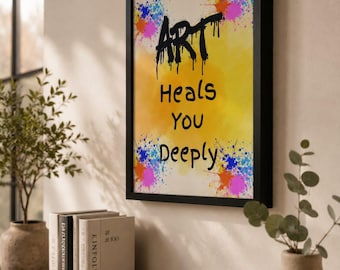May include: A framed wall art print featuring a yellow background with colorful paint splatters in blue, orange, and pink. The text ART HEALS YOU DEEPLY is printed in black, with the word ART appearing in a dripping, graffiti-style font.