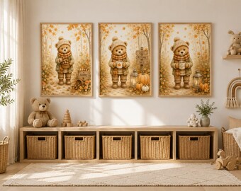 May include: Three framed wall art prints featuring a teddy bear wearing a knit hat and scarf in an autumn forest setting with orange leaves, pumpkins, and lanterns. The center print includes a wooden sign with the text Cozy Autumn Days.