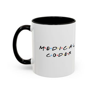 May include: A white ceramic mug with a black handle and interior. The text MEDICAL CODER is printed in black on the front, with small coloured dots separating each letter in blue, red, and yellow, mimicking a classic television show logo style.