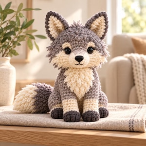 May include: A crocheted stuffed animal shaped like a wolf with grey and cream-colored yarn. The wolf has large black plastic eyes, a black stitched nose, and a bushy tail. The texture of the yarn is thick and soft, creating a plush appearance.