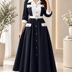 May include: A long-sleeved midi dress in black and white featuring a collared neckline, a button-down front with gold-toned buttons, two chest pockets with flaps, and a matching white belt with a rectangular buckle at the waist.