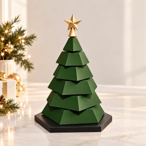 May include: A decorative Christmas tree sculpture composed of five stacked, dark green, geometric, trapezoidal tiers. The tree is topped with a gold-coloured, five-pointed star and rests on a solid black, hexagonal base, creating a layered structure.