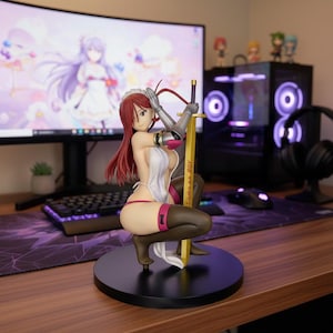 May include: A female anime-style figurine with long red hair, wearing a white apron-style garment, dark thigh-high stockings, and silver arm armor. The figure is kneeling on a black circular base, holding a gold sword with the text "Come on BOY".
