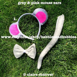 May include: Grey and pink mouse ears headband with a grey fluffy tail. The headband has a pink circle on each ear. The tail is long and fluffy. The text "www.etsy.com/shop/babblesandbubbles" is visible in the image.
