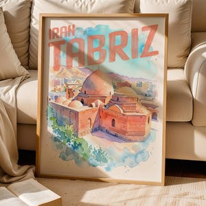 May include: A framed watercolor-style art print featuring a cityscape of Tabriz, Iran. The illustration depicts a large domed building in warm orange and brown tones, set against a soft blue and green watercolor wash background with the text IRAN TABRIZ.