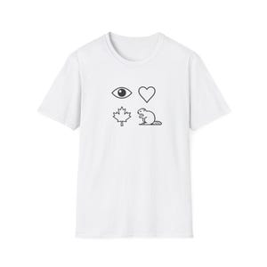 May include: A white short-sleeved t-shirt featuring a black graphic print on the chest. The design consists of four distinct icons arranged in a square grid: an eye, a heart, a maple leaf, and a beaver, all rendered in a simple line art style.