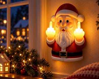 May include: A wall-mounted Santa Claus light fixture featuring a red and white suit, a black belt with a gold buckle, and a white beard. The Santa figure is illuminated from within, with both hands raised, each displaying a middle finger gesture.
