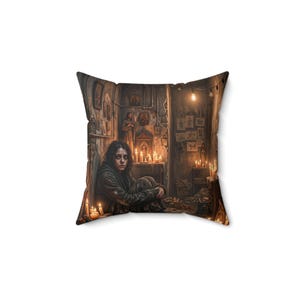 May include: A square throw pillow featuring a printed illustration of a person sitting on the floor in a dimly lit, candlelit room. The scene includes religious icons on the walls, numerous lit candles, and sketches pinned to the wall.