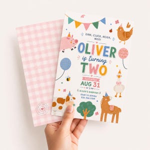 May include: A white birthday invitation card featuring colorful farm animal illustrations, bunting, and the text OINK, CLUCK, NEIGH, MOO! OLIVER is turning TWO, SATURDAY, AUG 31 AT 2 PM, OLIVER'S BARNYARD, RSVP TO SOPHIA 555.555.5555, paired with a pink gingham envelope.
