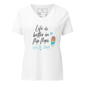 May include: A white V-neck t-shirt featuring the black text Life is better in flip flops, a small teal heart, a colorful flip flop graphic with a sunset beach scene, and the teal text Wear The Flipside with a small teal heart underneath.